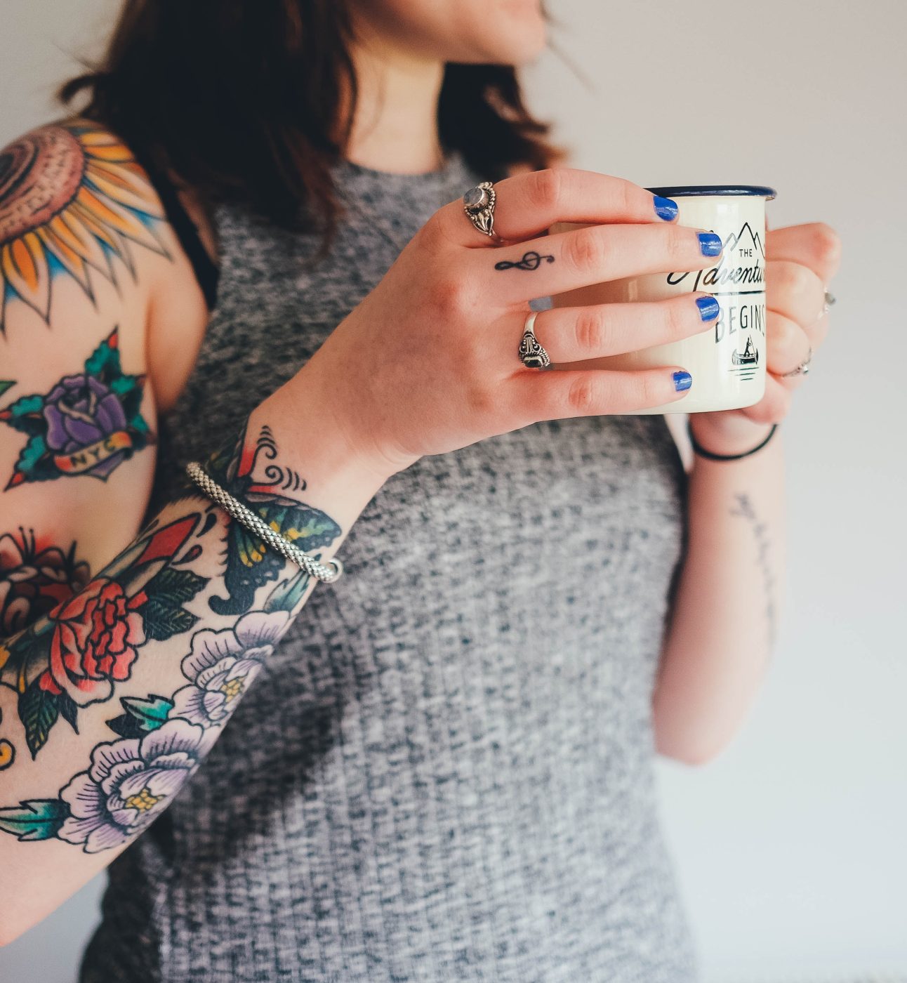 Tattooed lady holding a mug