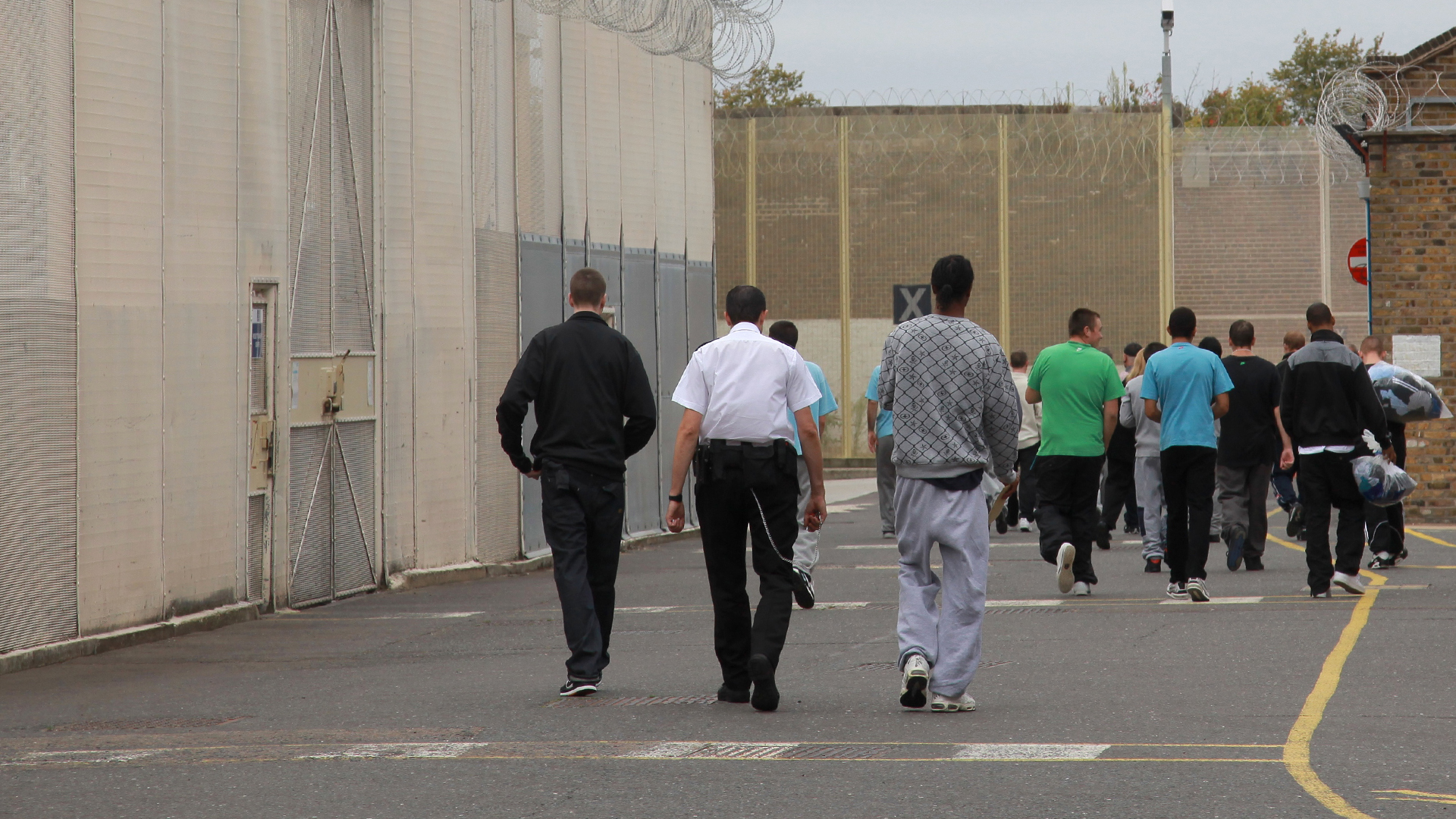 People walking into the prison gates