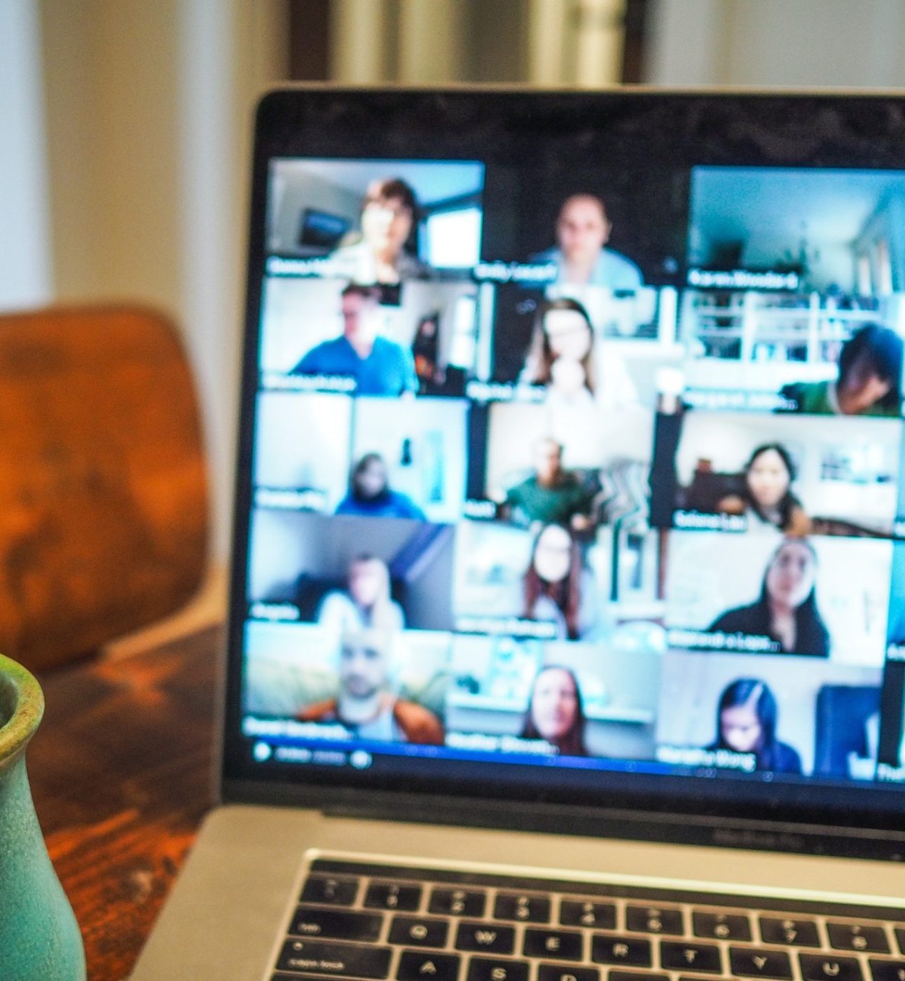 A laptop screen with a Zoom online meeting taking place